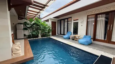 a swimming pool in the backyard of a house at Emstaliese & Palmarosa Villas Seminyak in Legian