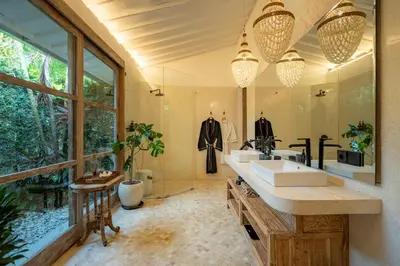 a bathroom with a sink and a large window at Luxe Bali Seminyak Villa by Betterplace in Seminyak