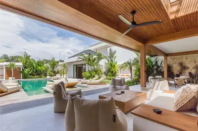 an outdoor living room with a ceiling fan at Villa Selena Space Luxury 4BR 15m Pool BBQ Staffed in Seminyak