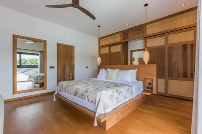 a bedroom with a large bed and a large mirror at Villa Selena Space Luxury 4BR 15m Pool BBQ Staffed in Seminyak