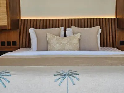 a bedroom with a large bed with palm trees on it at Villa Selena Space Luxury 4BR 15m Pool BBQ Staffed in Seminyak
