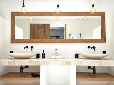 a bathroom with two sinks and a mirror at Villa Selena Space Luxury 4BR 15m Pool BBQ Staffed in Seminyak