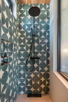 a shower in a bathroom with a green and white wall at Villa Batu, Superb 4BR beachside in Canggu