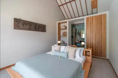 a bedroom with a white bed with white pillows at Villa Batu, Superb 4BR beachside in Canggu
