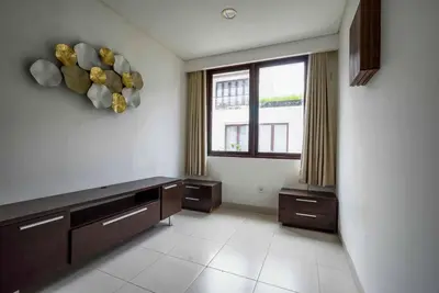 a large kitchen with a large window and a counter at Norm Villa Kuta in Kuta