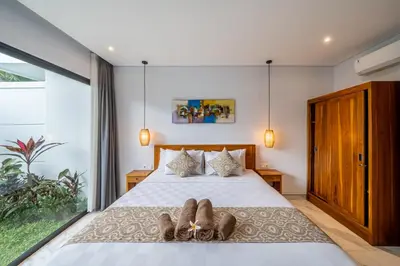 a bedroom with two people laying on a bed at Luxury 2BR Villas in Seminyak Central in Seminyak