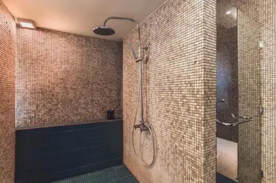 a bathroom with a shower with a glass door at Chaesa Comfortable 1 BR Royal Private Pool Villa in Kerobokan