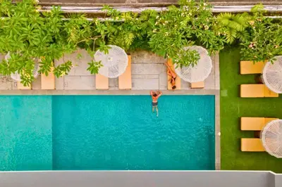 an overhead view of a man standing in a swimming pool at Varnika Peaceful 1 BR Suite Double Room in Kerobokan