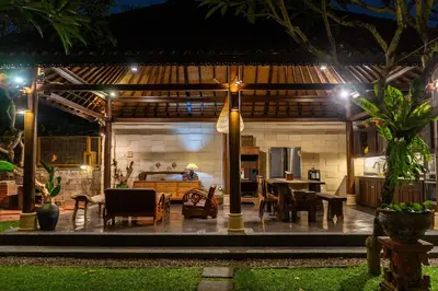 a patio of a house at night with lights at Puri Sekar Bali in Pesanggaran