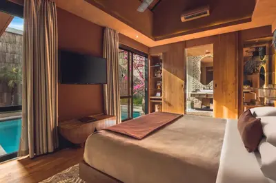 a bedroom with a large bed and a large window at Yaseera Aesthetic 1 BR Grand Smart Private Pool Villa in Seminyak