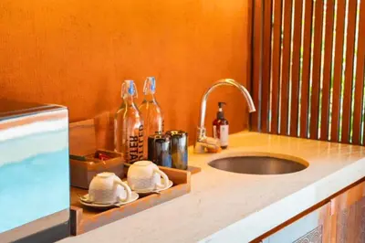 a kitchen counter top with a sink and a sink at Yaseera Aesthetic 1 BR Grand Smart Private Pool Villa in Seminyak