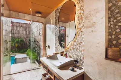 a bathroom with a sink and a mirror at Yaseera Aesthetic 1 BR Grand Smart Private Pool Villa in Seminyak