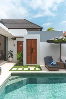 a villa with a swimming pool and a house at 3BRVilla Minutes from Seminyak, Petitenget, Canggu in Kerobokan