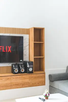 a entertainment center with a tv and speakers at 3BRVilla Minutes from Seminyak, Petitenget, Canggu in Kerobokan