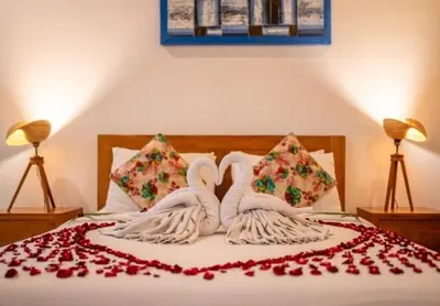 a bed with two swans made out of roses at Prime Seminyak 2BR Villas in Seminyak