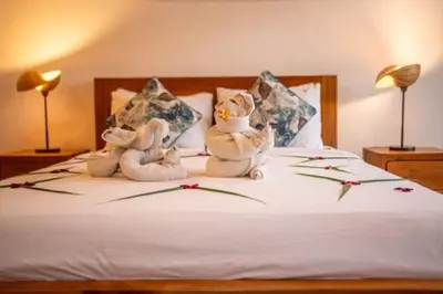 two stuffed animals sitting on top of a bed at Prime Seminyak 2BR Villas in Seminyak