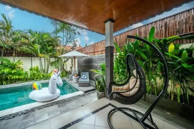 a swimming pool with a float and a toy horse next to it at Prime Seminyak 2BR Villas in Seminyak