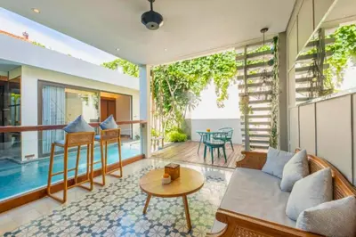 a living room with a couch and a table at Tarasari Stunning 1 BR Grand Private Pool Villa With Bathtub in Seminyak