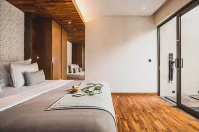 a bedroom with a large bed in a room at Tarasari Stunning 1 BR Grand Private Pool Villa With Bathtub in Seminyak
