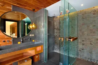 a bathroom with a glass shower and a sink at Tarasari Stunning 1 BR Grand Private Pool Villa With Bathtub in Seminyak