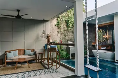 a house with a swimming pool and a living room at Tarasari Stunning 1 BR Grand Private Pool Villa With Bathtub in Seminyak