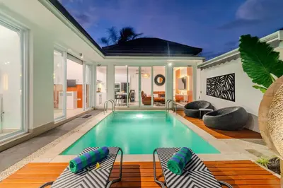 a swimming pool in the middle of a house at Coastal Bliss Private 2BR Pool Villa Jimbaran in Jimbaran