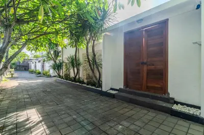 a wooden door on the side of a house at Coastal Bliss Private 2BR Pool Villa Jimbaran in Jimbaran