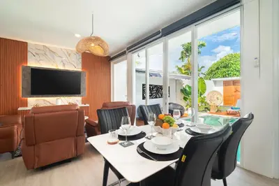 a dining room with a table and chairs at Coastal Bliss Private 2BR Pool Villa Jimbaran in Jimbaran