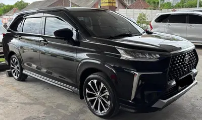 a black suv parked in a parking lot at Mobil Veloz Q CVT in Ngurah Rai International Airport