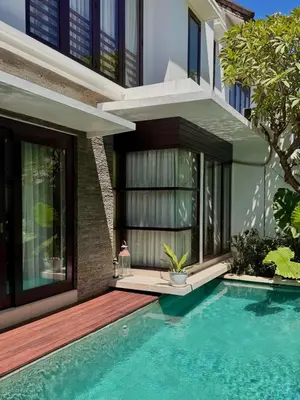 a house with a swimming pool in front of a house at Villa Hale Mahina, Bali in Kerobokan