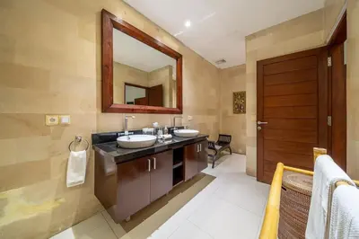 a bathroom with two sinks and a mirror at Villa Rajawali 3BR Private Villa Near Beach in Canggu