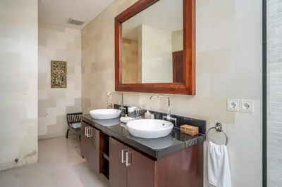 a bathroom with two sinks and a mirror at Villa Rajawali 3BR Private Villa Near Beach in Canggu
