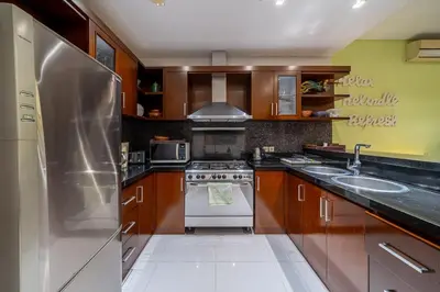 a kitchen with a stove and a sink at Villa Rajawali 3BR Private Villa Near Beach in Canggu