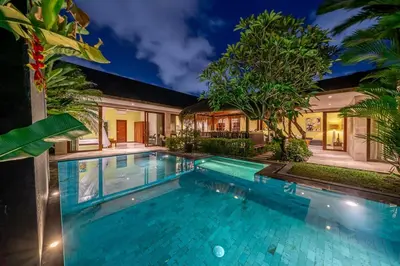a swimming pool in front of a house at Villa Rajawali 3BR Private Villa Near Beach in Canggu