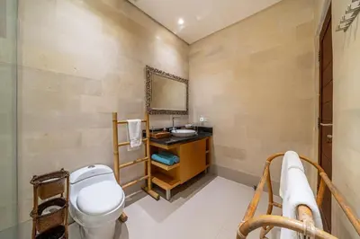 a bathroom with a toilet and a sink at Villa Samsara 3BR Pool Villa Near Berawa Beach in Canggu