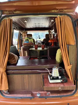 an open back end of a van with a kitchen in it at Wandervan - Bali Campervan Rental in Kuta