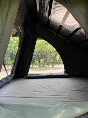 an opening in a tent with a bed inside at Wandervan - Bali Campervan Rental in Kuta