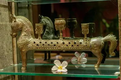 a golden horse on a glass shelf with flowers at 6 BDR Boutique villa in heart of Seminyak in Seminyak