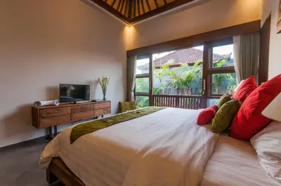 a bedroom with a large bed and a window at 6 BDR Boutique villa in heart of Seminyak in Seminyak