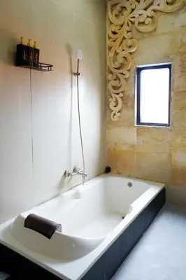a white bath tub in a bathroom with a window at 3Bedrooms Villa with Pool West Sanur - Casa Del Sol in Sanur