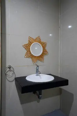 a bathroom sink with a mirror on a wall at 3Bedrooms Villa with Pool West Sanur - Casa Del Sol in Sanur