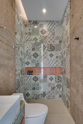 a bathroom with a toilet and a mosaic wall at Elegant Villa Vibhava 2BR in Central Umalas in Kerobokan