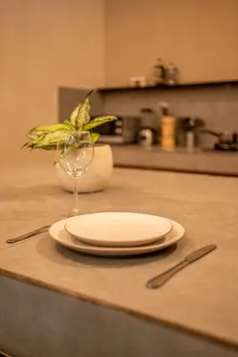 a plate and a wine glass sitting on a counter at Villa Aditya Seminyak in Seminyak