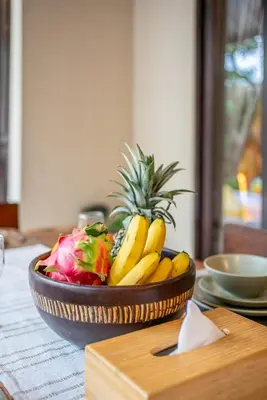 a bowl of fruit sitting on top of a table at Villa Aditya Seminyak in Seminyak