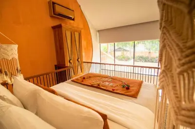 a bedroom with a bed with a tray on it at Tamasvini Romantic 1 BR Grand Private Pool Villa With Bathtub in Seminyak