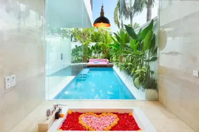 a bathroom with a swimming pool with a heart in a sink at Halina Cozy 2 BR Private Pool Villa With Bathtub in Legian