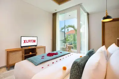 a living room with a couch and a television at Halina Cozy 2 BR Private Pool Villa With Bathtub in Legian