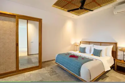 a bedroom with a large bed and a mirror at Halina Cozy 2 BR Private Pool Villa With Bathtub in Legian