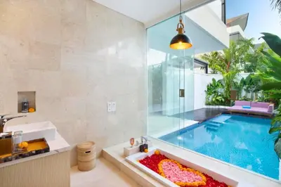 a bathroom with a swimming pool and a sink at Halina Cozy 2 BR Private Pool Villa With Bathtub in Legian