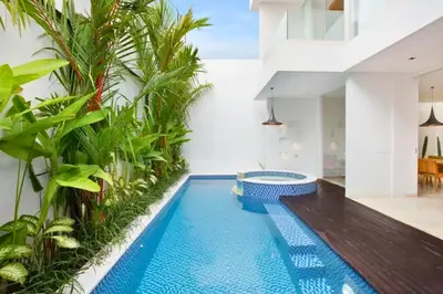 a swimming pool in a house with plants at Heleina Elegant 3 BR Royal Private Pool Villa With Jacuzzi in Legian